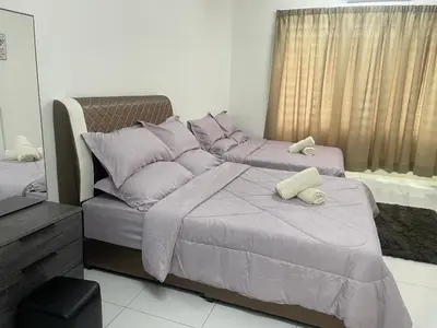 a bedroom with two beds with purple pillows at ZaraVip homestay in Lahat