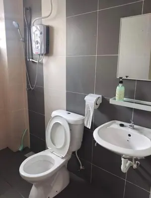 a bathroom with a toilet and a sink at ZaraVip homestay in Lahat