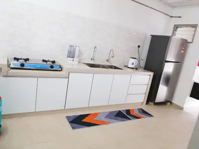 a kitchen with a sink and a refrigerator at Destiny Homestay in Sungai Petani