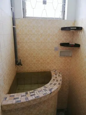 a bathroom with a shower with a tiled tub at Destiny Homestay in Sungai Petani