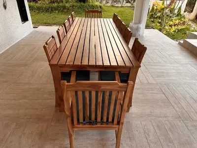 a wooden table with chairs around it on a patio at The White Horse in Cameron Highlands