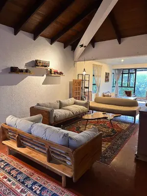 a large living room with couches and a table at The White Horse in Cameron Highlands