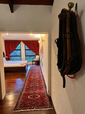 a room with a hallway with a rug on the wall at The White Horse in Cameron Highlands