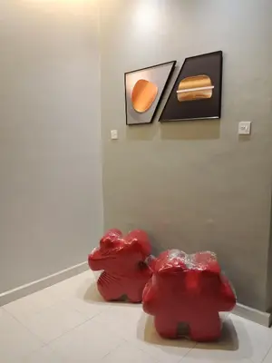 two red sculptures on display in a museum at 61 Homestay in Sitiawan