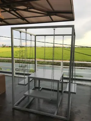 a swing room with a view of a field at Bendang Homes - Sekinchan Homestay in Kampong Sungai Leman
