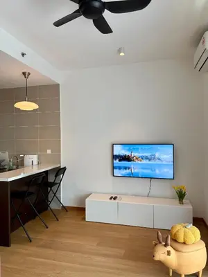 a living room with a flat screen tv on a wall at Ipoh Peaceful Onsen studio Lost World Tambun in Tambun