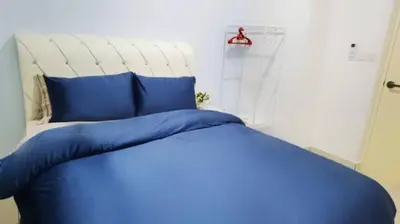 a blue bed with blue pillows in a bedroom at ROMANCE FULL HOUSE THREE PREMIER SUITE in Butterworth