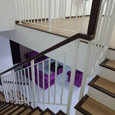 a stairway with a white railing and purple objects at SBB Star Homestay in Sungai Petani