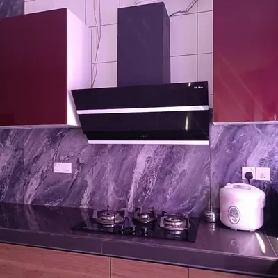 a kitchen with a black counter top with a stove at SBB Star Homestay in Sungai Petani