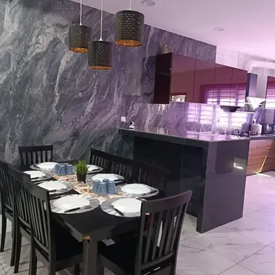 a dining room with a black table and chairs at SBB Star Homestay in Sungai Petani