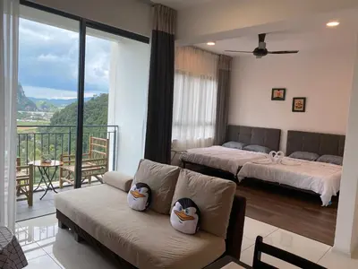 a living room with two beds and a couch at Sunway City Onsen COSY HOME Tambun Ipoh in Ipoh