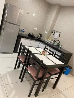 a kitchen with a table and chairs in a kitchen at Sunway City Onsen COSY HOME Tambun Ipoh in Ipoh