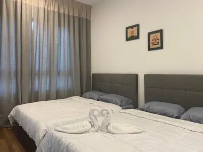 two beds in a bedroom with white sheets at Sunway City Onsen COSY HOME Tambun Ipoh in Ipoh