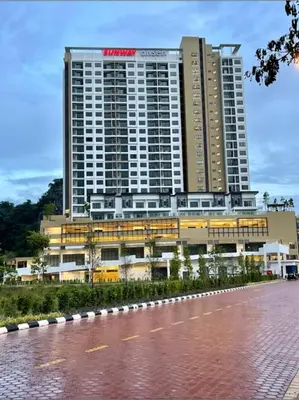 a hotel with a large building in front of a road at Sunway City Onsen COSY HOME Tambun Ipoh in Ipoh