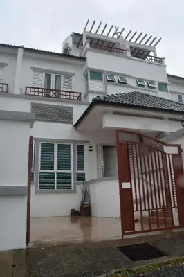 a white house with a gate in front of it at Nimah Seaview Homestay in George Town
