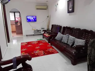 a living room with two leather couches and a red rug at Idaman guesthouse Malay FAMILY ONLY in Kubang Semang