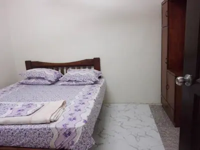a bedroom with a bed with purple sheets and pillows at Idaman guesthouse Malay FAMILY ONLY in Kubang Semang
