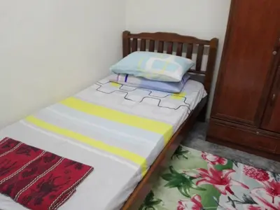a small bed with two pillows on top of it at Idaman guesthouse Malay FAMILY ONLY in Kubang Semang