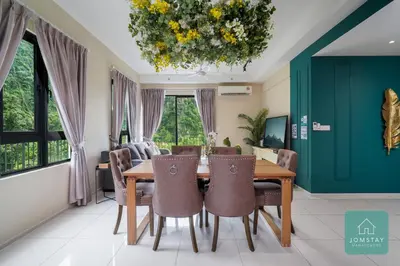 a dining room with a table and chairs at JOMSTAY Sunway Onsen Suites Ipoh - Lost World of Tambun Ipoh Waterpark in Tambun