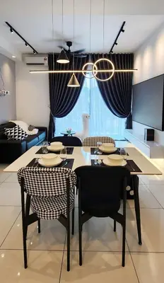 a dining room with a table and chairs in a room at JOMSTAY Sunway Onsen Suites Ipoh - Lost World of Tambun Ipoh Waterpark in Tambun