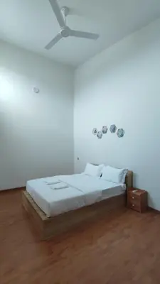 a white bedroom with a bed and a ceiling at Gopeng Serumah Holiday House in Gopeng