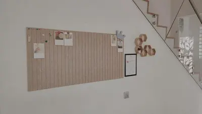 a staircase with a wall with magnets and papers on it at Gopeng Serumah Holiday House in Gopeng