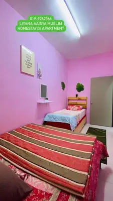 a bedroom with pink walls and a bed in it at LIYANA AAISYA HOMESTAY - 10 UNITs - JOINT VENTURE PARTNERS in Tanah Rata