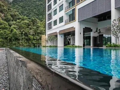 a swimming pool in front of a building at Cozy Suite with 270 Degree Mountain and Theme Park Views in Ipoh