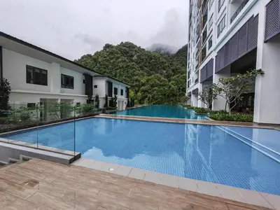 a swimming pool in the middle of a building at Cozy Suite with 270 Degree Mountain and Theme Park Views in Ipoh