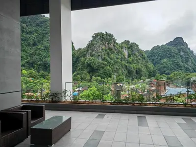 a room with a view of a mountain at Cozy Suite with 270 Degree Mountain and Theme Park Views in Ipoh