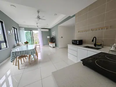 a kitchen with a table and a dining room at Cozy Suite with 270 Degree Mountain and Theme Park Views in Ipoh