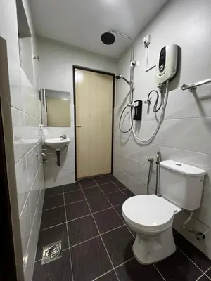 a bathroom with a toilet and a sink at Roomah Istana in Ipoh