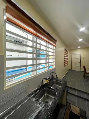 a kitchen with a sink and a window at Roomah Istana in Ipoh