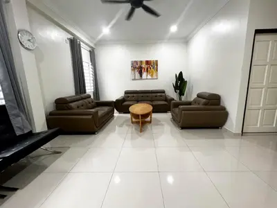 a living room with couches and a ceiling fan at Roomah Istana in Ipoh