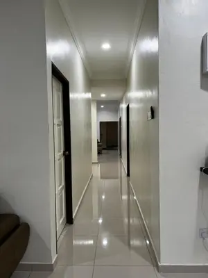 a hallway in a building with a door and white walls at Roomah Istana in Ipoh