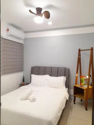 a bedroom with a white bed with a ceiling at Ipoh Homestay - Manhattan Condominium with Water Park & Leisure Facilities in Ipoh