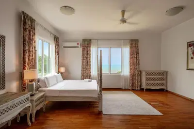 a bedroom with a bed and a large window at Panoramic Seaview Holiday Home - Batu Ferringhi in Batu Ferringhi