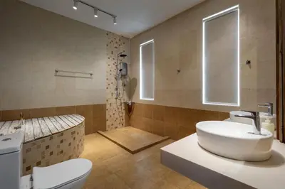 a bathroom with a white sink and a toilet at Panoramic Seaview Holiday Home - Batu Ferringhi in Batu Ferringhi