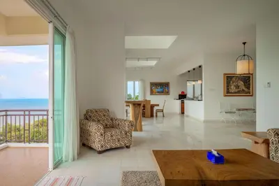 a living room with a view of the ocean at Panoramic Seaview Holiday Home - Batu Ferringhi in Batu Ferringhi