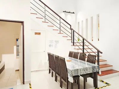 a dining room with a table and chairs and stairs at Ocean 27 Batu Ferringhi Shamrock Beach 6 Bedroom 22pax with Pool in Batu Ferringhi