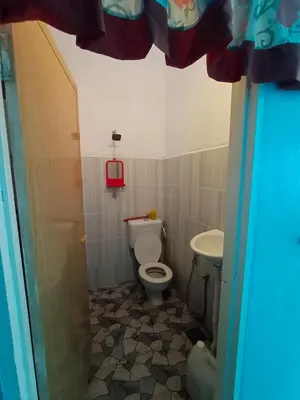 a bathroom with a toilet and a sink at Hazaff Homestay in Sungai Petani