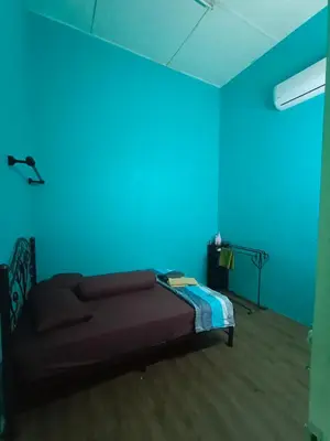 a bedroom with a blue room with a bed at Hazaff Homestay in Sungai Petani