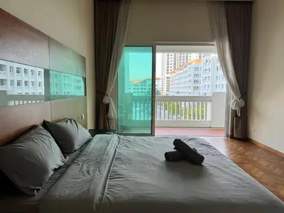 a bedroom with a bed with a remote control on it at Lucky Waterfront at Straits Quay Seaview or Non in Bagan Jermal