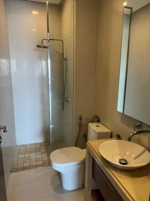 a bathroom with a toilet and a shower and a sink at Lucky Waterfront at Straits Quay Seaview or Non in Bagan Jermal