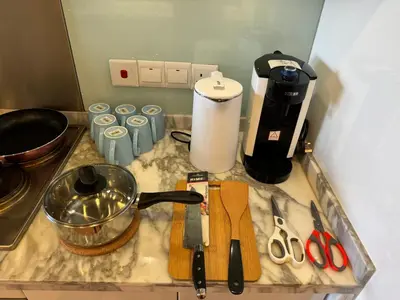 a kitchen counter with a counter top with a blender and scissors at Lucky Waterfront at Straits Quay Seaview or Non in Bagan Jermal