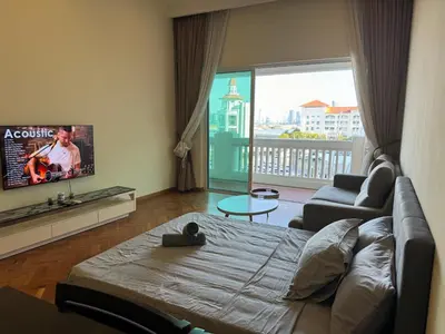 a living room with a couch and a tv at Lucky Waterfront at Straits Quay Seaview or Non in Bagan Jermal