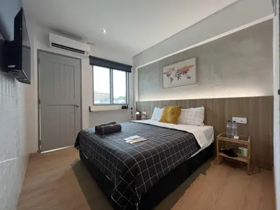 a bedroom with a large bed and a window at Ninety Guest House in Ipoh