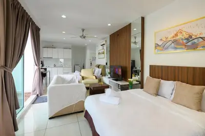 a bedroom with a large bed and a living room at Comfy Studio/Gurney/Mansion One in George Town
