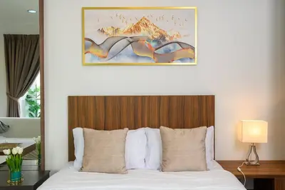 a bedroom with a bed with a wooden head board at Comfy Studio/Gurney/Mansion One in George Town