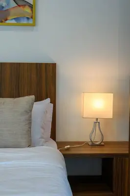 a bedroom with a bed and a lamp on a desk at Comfy Studio/Gurney/Mansion One in George Town